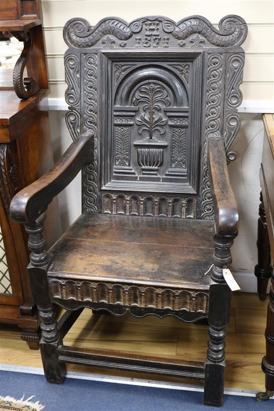 An antique carved oak Wainscot chair, bearing the date 1671